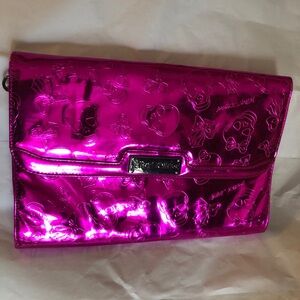 Betsey Johnson Skull and Bones Metallic Pink Embossed Clutch. Callout